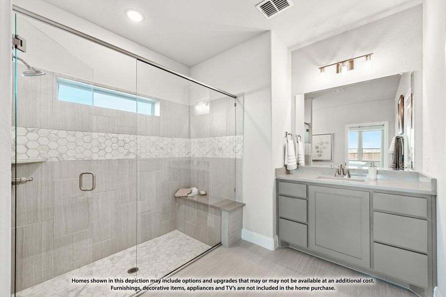 Bathroom with glass walk-in shower, tile walls, built-in bench, and gray vanity with double sinks Bathroom with glass walk-in shower, tile walls, built-in bench, and gray vanity with double sinks