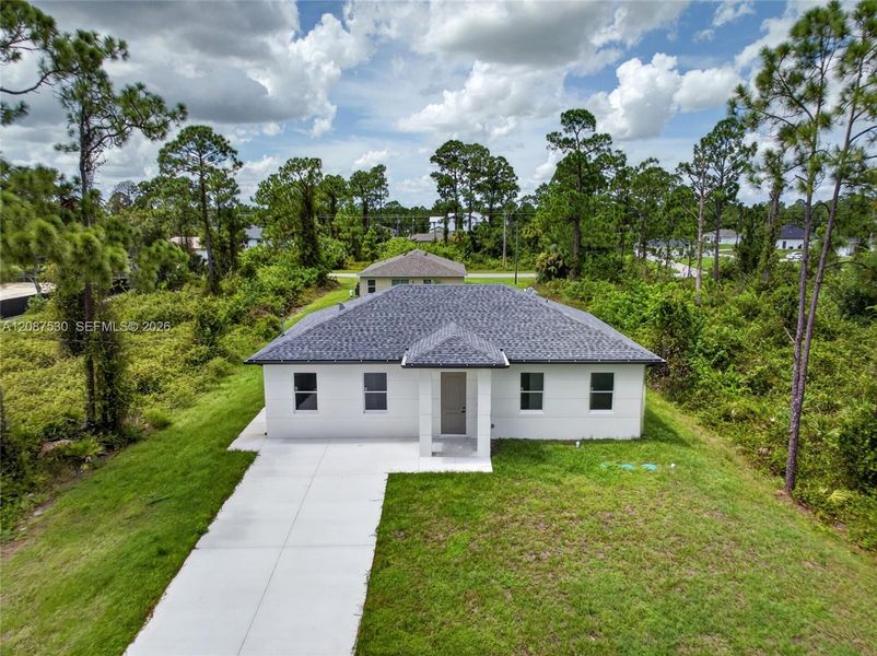 Front exterior of a new home in , Lehigh Acres, FL, highlighting curb appeal (Image 20).