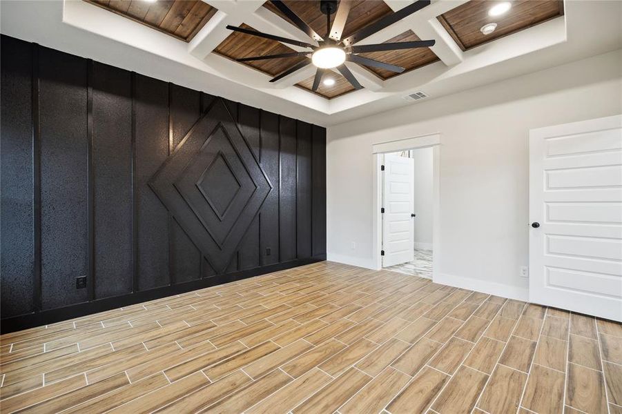 Empty room featuring coffered ceiling and beam ceiling