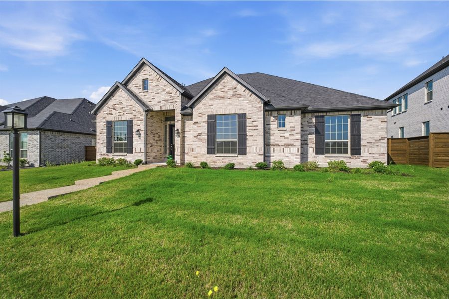 Front exterior of a new home in Solterra, Mesquite, TX, highlighting curb appeal (Image 24). Front exterior of a new home in Solterra, Mesquite, TX, highlighting curb appeal (Image 24).