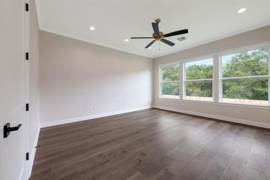Unfurnished room with crown molding, ceiling fan, dark wood-style flooring, and recessed lighting Unfurnished room with crown molding, ceiling fan, dark wood-style flooring, and recessed lighting