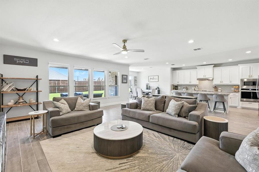 Living area with recessed lighting, light wood-style floors, and ceiling fan