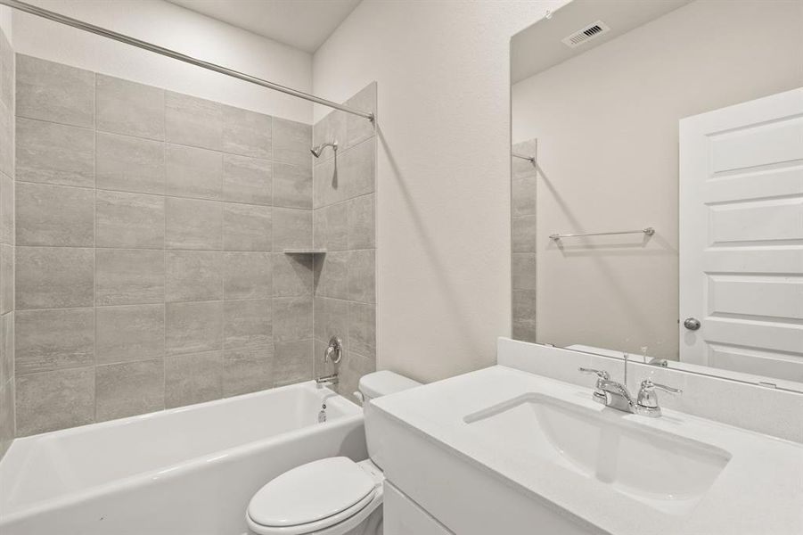 Step into the stunning secondary bathroom on the main floor, where a lavish shower/tub combo, oversized mirror and sleek finishes await.