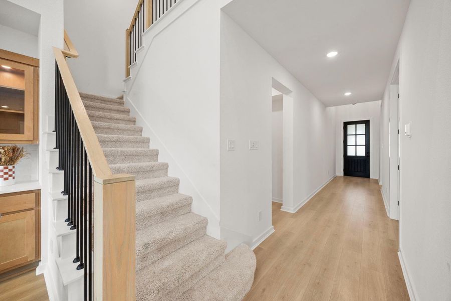 This grand staircase is wide, open, and bright.