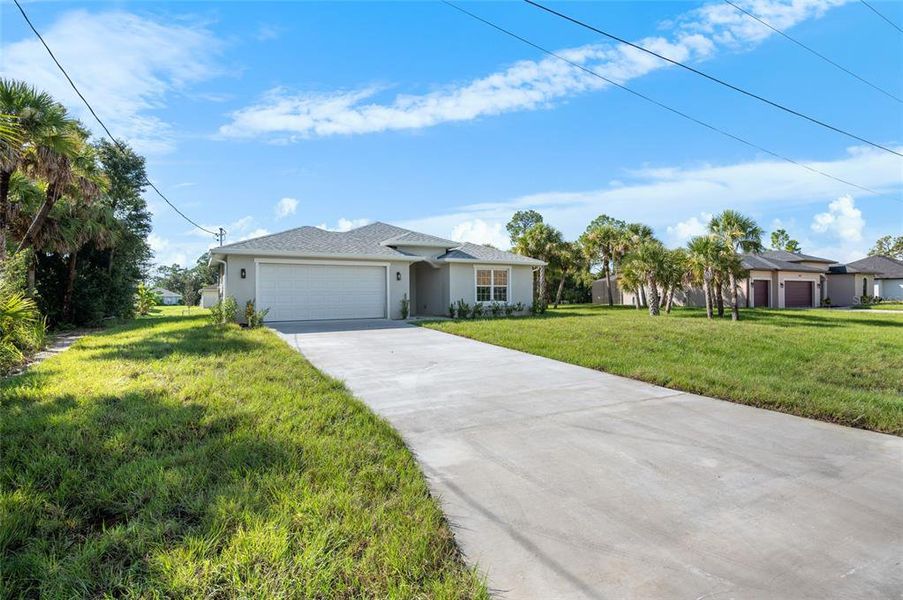 Front exterior of a new home in , North Port, FL, highlighting curb appeal (Image 2). Front exterior of a new home in , North Port, FL, highlighting curb appeal (Image 2).