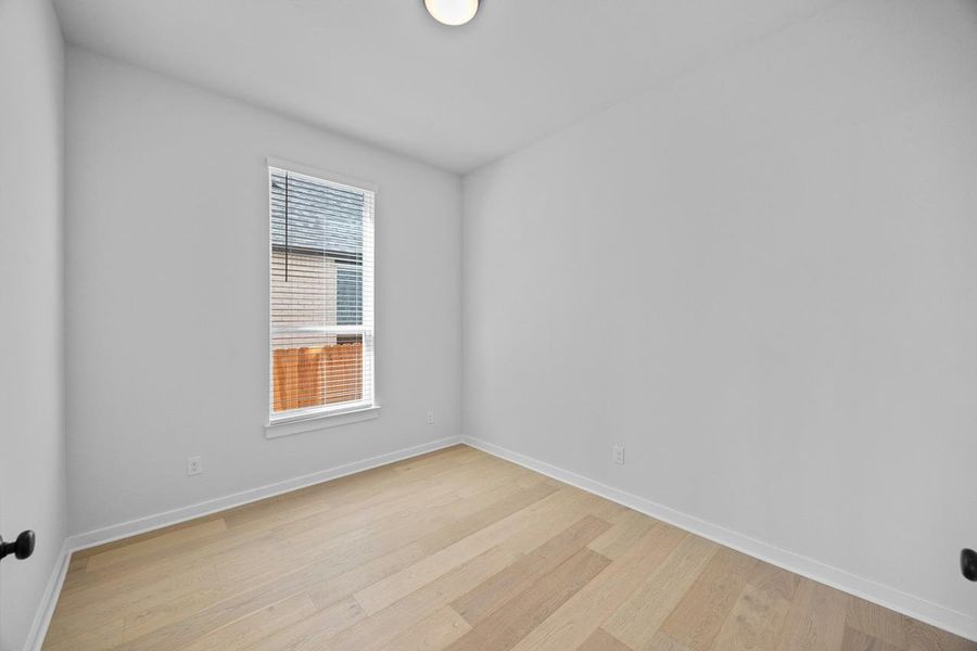 Empty room featuring light wood-style flooring and baseboards Empty room featuring light wood-style flooring and baseboards