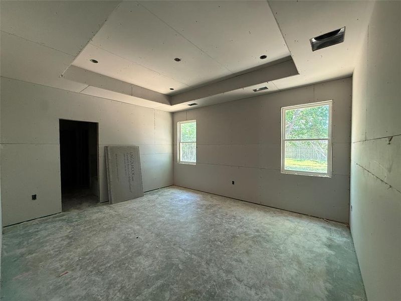 Recessed lighting illuminates a tray ceiling design