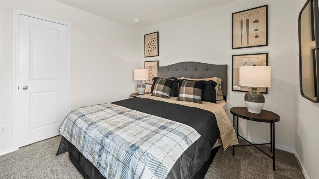 Carpeted bedroom featuring baseboards