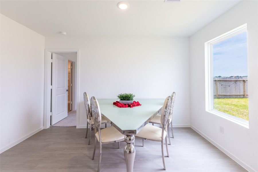 The dining area offers a large window that provides natural light along with a wonderful view of the backyard. The dining area offers a large window that provides natural light along with a wonderful view of the backyard.