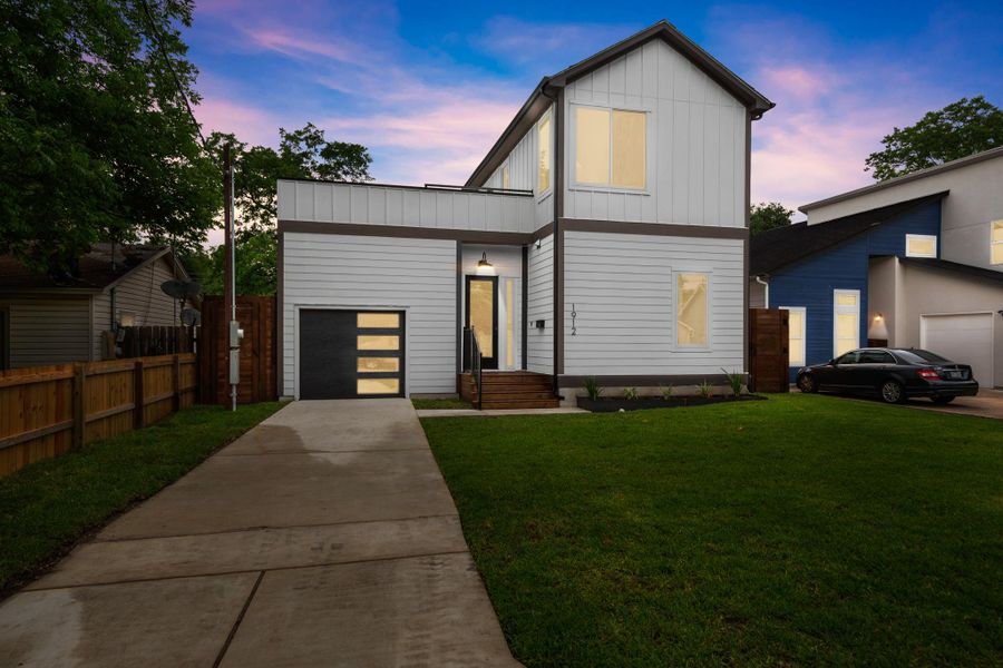 Contemporary home with concrete driveway, board and batten siding, and a garage Contemporary home with concrete driveway, board and batten siding, and a garage