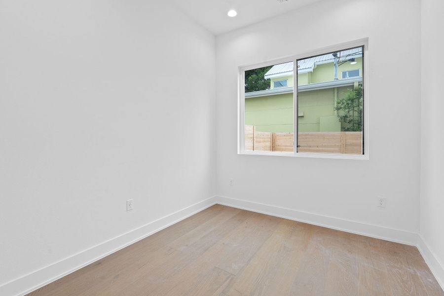 Spare room featuring light wood finished floors and recessed lighting