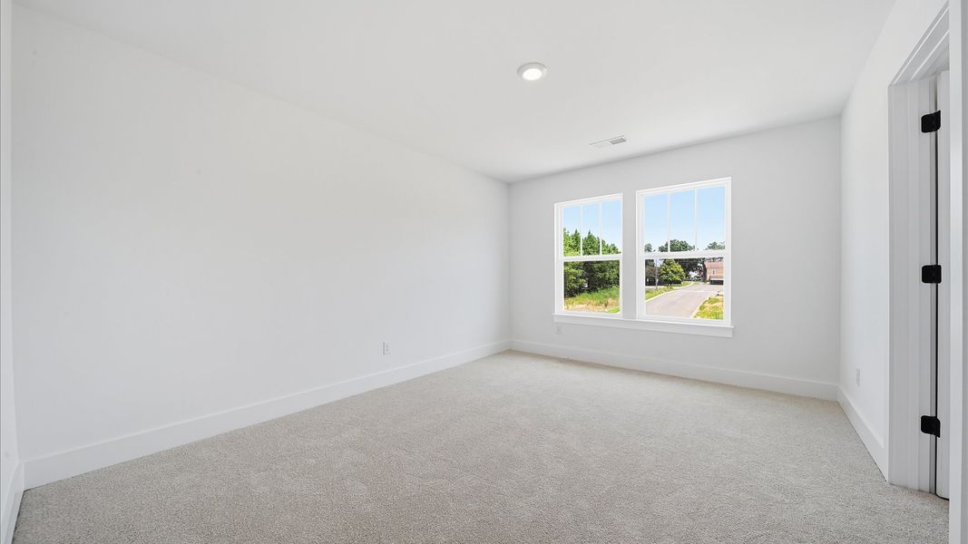 Superior comfort in this light-filled bedroom with plush carpeting and thoughtfully placed large windows Superior comfort in this light-filled bedroom with plush carpeting and thoughtfully placed large windows