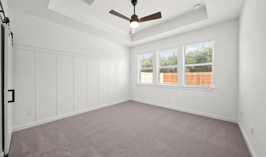 Conveniently located downstairs, the primary bedroom offers ample space for your king-sized furnishings & more.