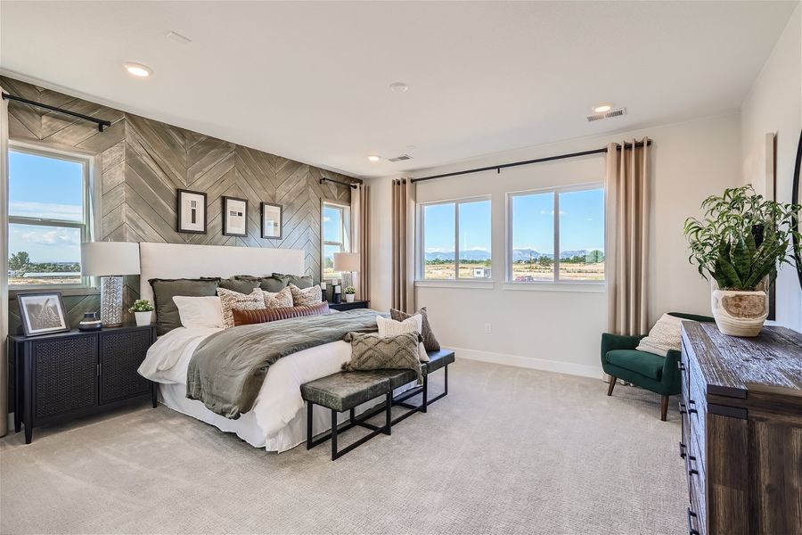 A bedroom with a large window. A bedroom with a large window.