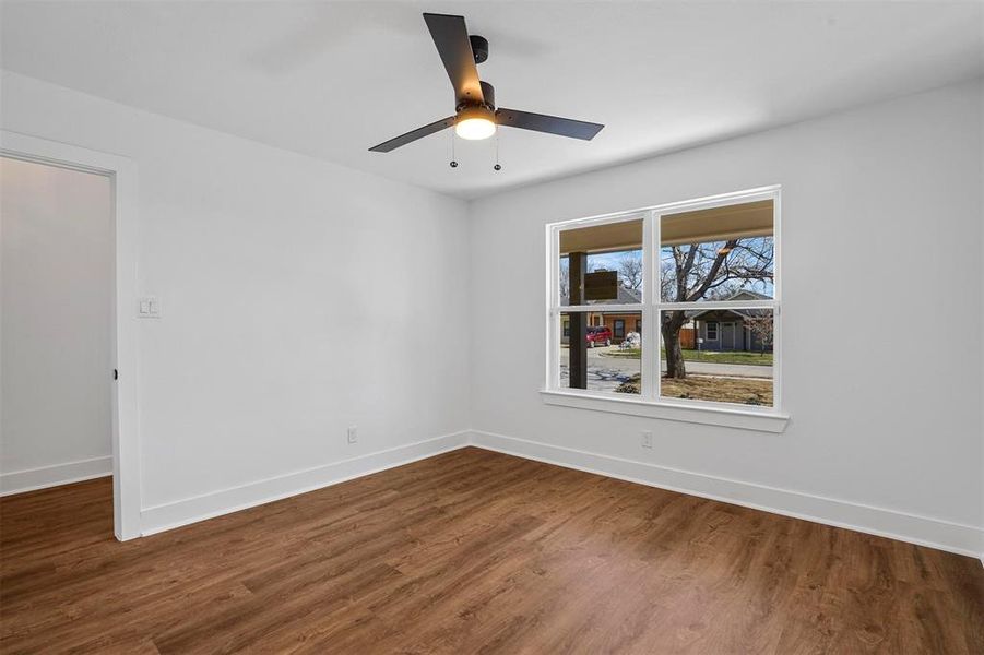 Unfurnished room featuring ceiling fan, baseboards, and wood finished floors