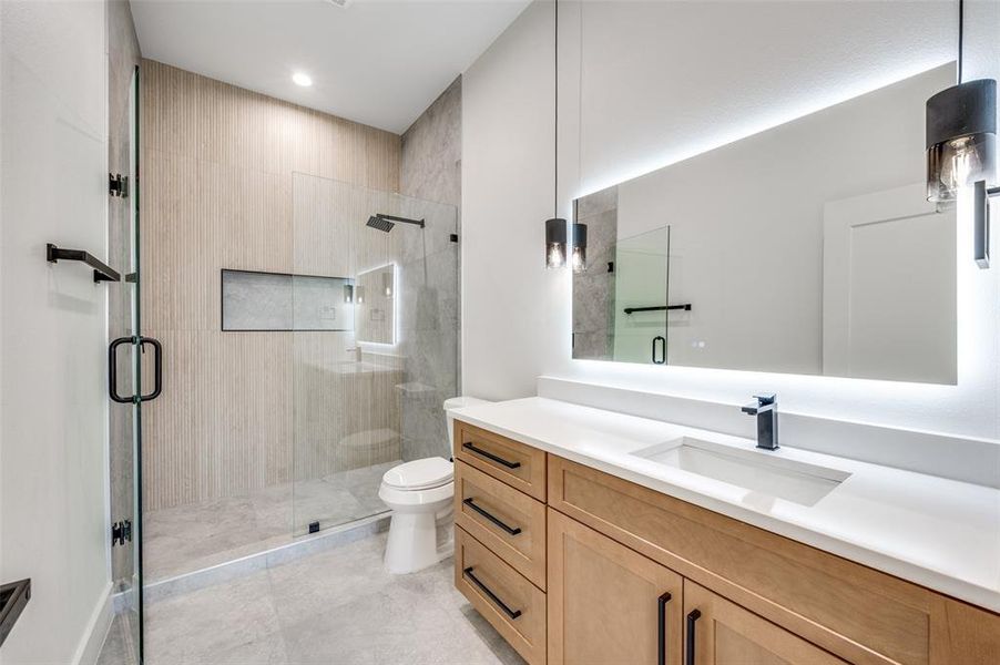 Bathroom with vanity and a stall shower