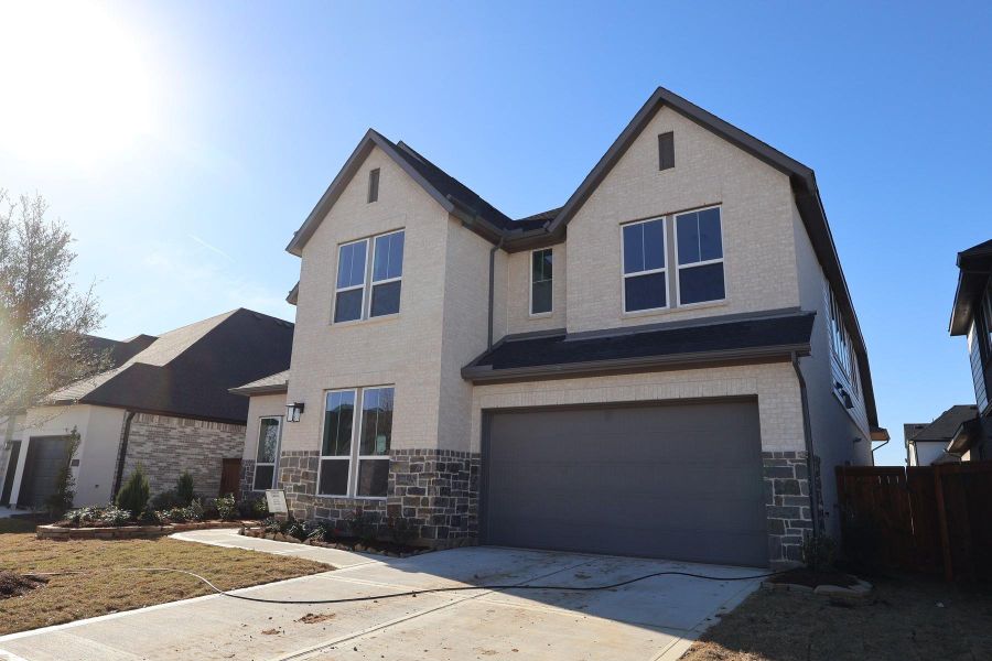Front exterior of a new home in Dunham Pointe, Cypress, TX, highlighting curb appeal (Image 18). Front exterior of a new home in Dunham Pointe, Cypress, TX, highlighting curb appeal (Image 18).