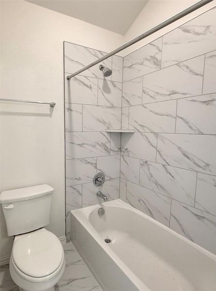 Bathroom with marble finish floors and shower / tub combination Bathroom with marble finish floors and shower / tub combination