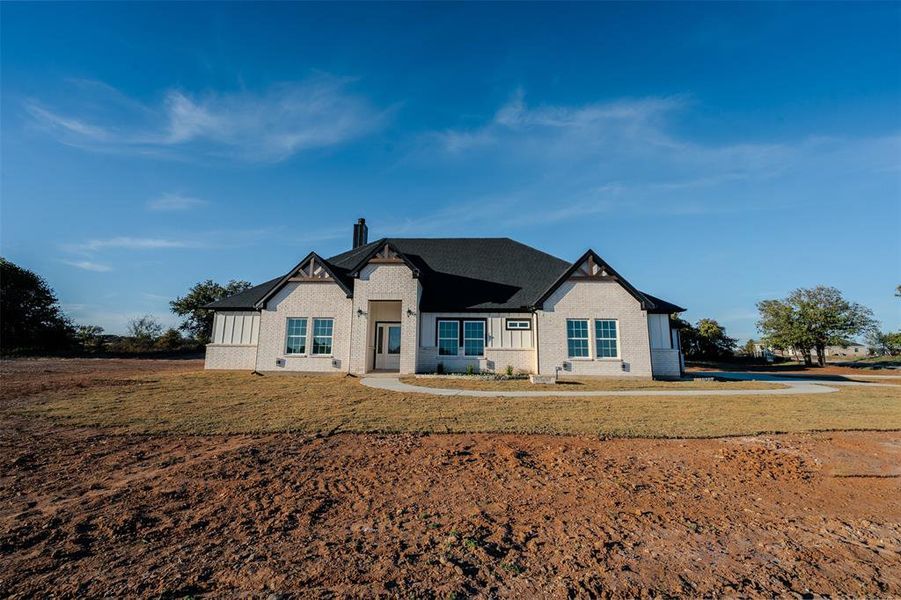 View of front facade with brick siding and a front lawn View of front facade with brick siding and a front lawn