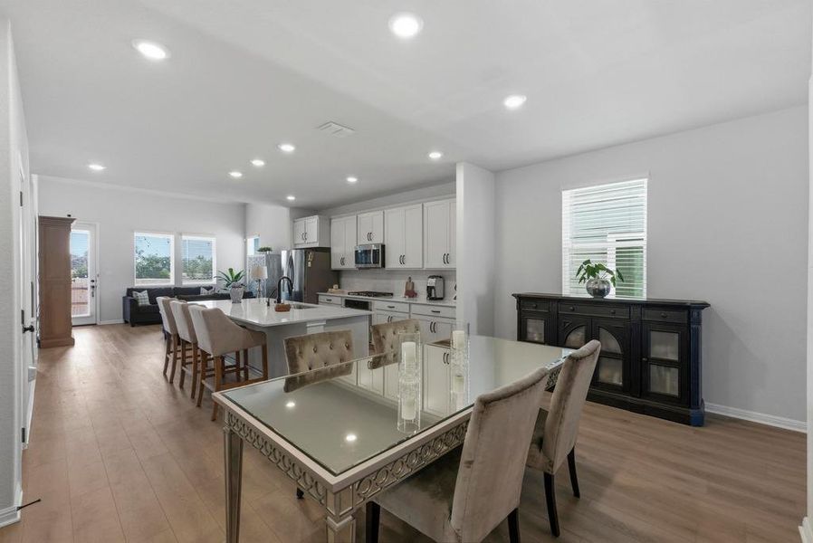 Dining area with light wood finished floors, recessed lighting, and healthy amount of natural light