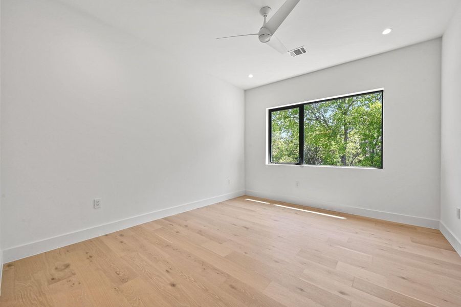 Empty room featuring light wood finished floors, recessed lighting, and ceiling fan
