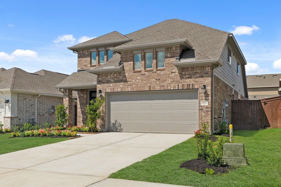 Front exterior of a new home in The Trails, New Caney, TX, highlighting curb appeal (Image 16).