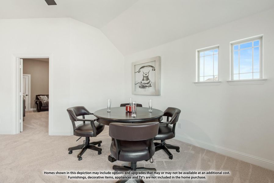 Bonus room with vaulted ceiling, round game table, four leather chairs, and carpet flooring