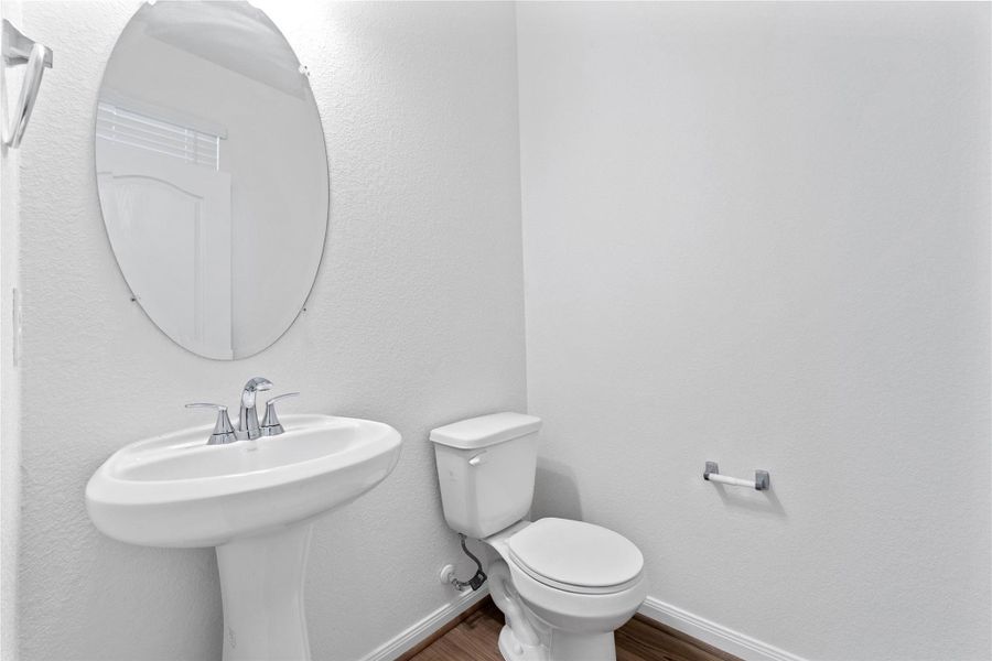 Conveniently located on the main floor, this powder room is perfect for guests and offers a stylish touch. Conveniently located on the main floor, this powder room is perfect for guests and offers a stylish touch.