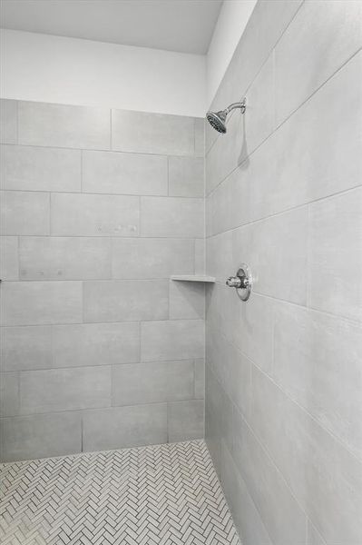 Full bath featuring tiled shower