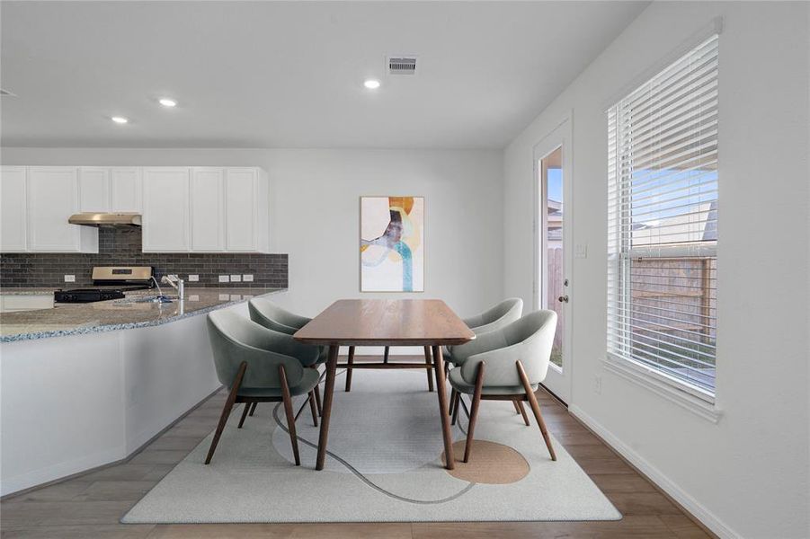 Make memories gathered around the table with your family and friends! The dining area features high ceilings, large windows with privacy blinds, and easy access to your kitchen and family room.