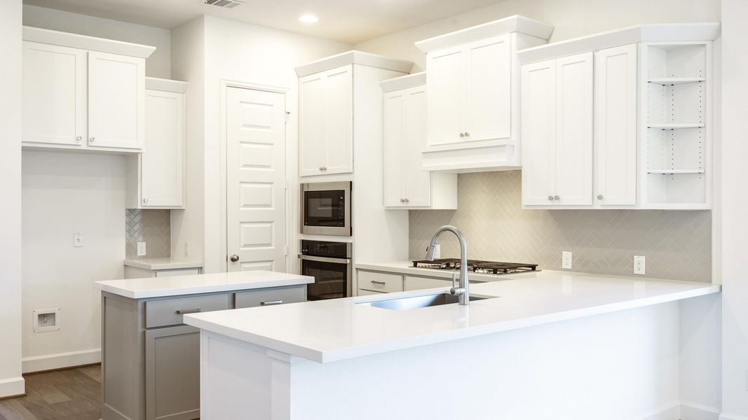 Kitchen with open shelves, a kitchen island, backsplash, white cabinets, and oven Kitchen with open shelves, a kitchen island, backsplash, white cabinets, and oven