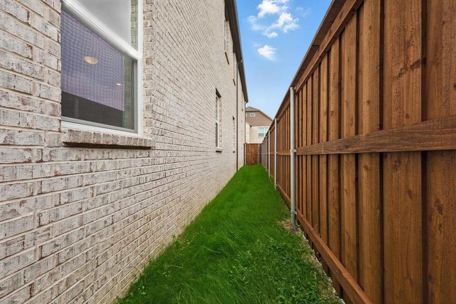 View of property exterior with brick siding