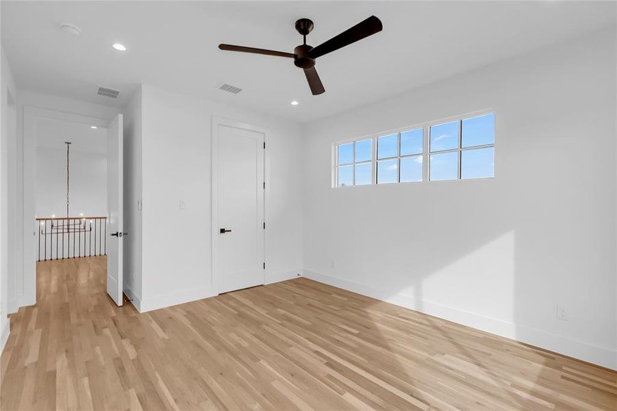 Unfurnished bedroom with recessed lighting, light wood finished floors, and ceiling fan Unfurnished bedroom with recessed lighting, light wood finished floors, and ceiling fan