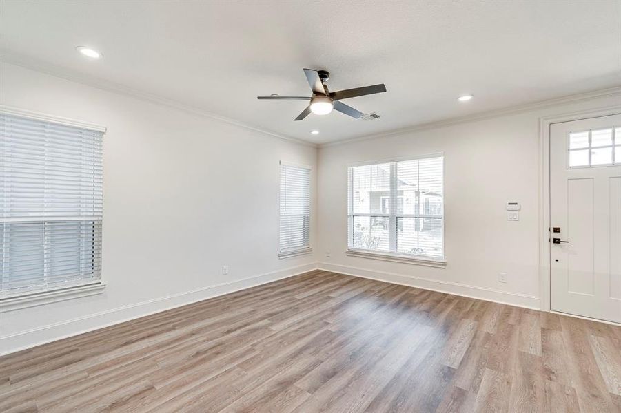 Foyer featuring ornamental molding, ceiling fan, and light wood finished floors Foyer featuring ornamental molding, ceiling fan, and light wood finished floors