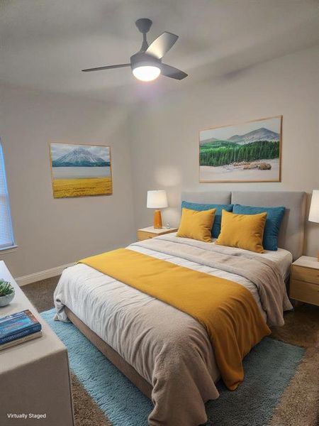 Bedroom featuring ceiling fan and dark carpet