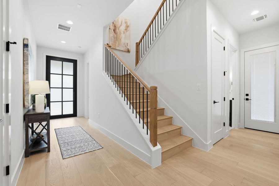 Entrance foyer featuring recessed lighting, stairway, and light wood-style flooring