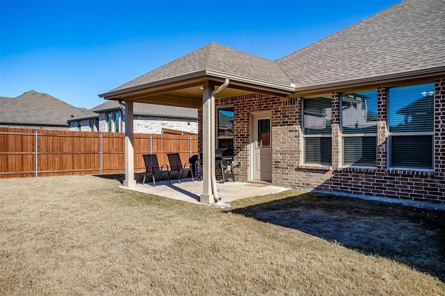 Back of property featuring a patio area and a yard