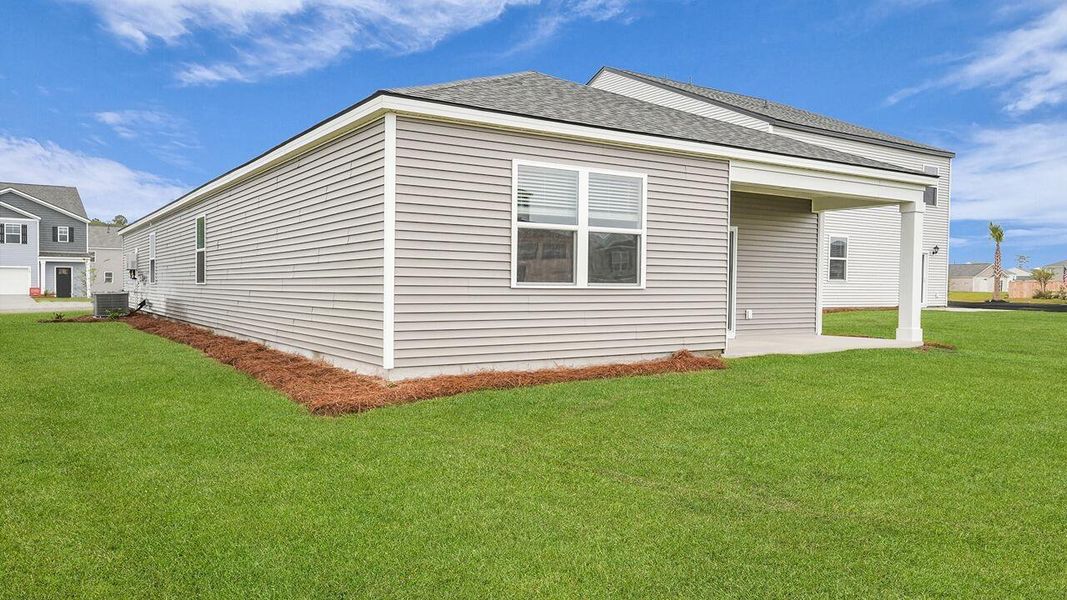 Exterior details and patio area of a home in Pine Hills at Cane Bay, Summerville (Image 18).