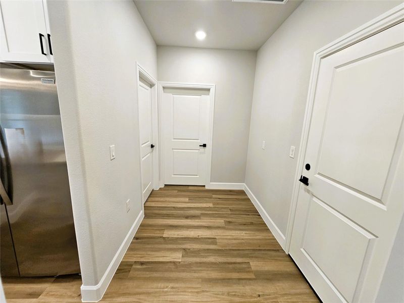 Hall featuring light wood-style flooring and recessed lighting