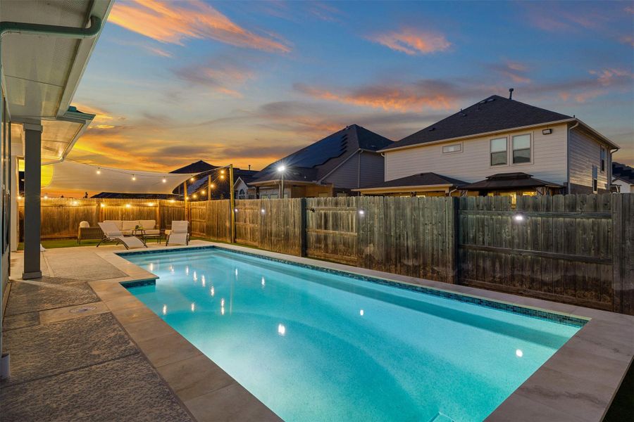 The fully fenced yard adds privacy and peace of mind, with a French drain in place to keep the area ready for year-round use