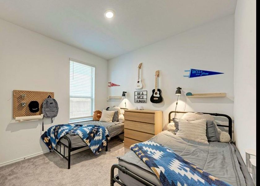 Carpeted bedroom featuring baseboards Carpeted bedroom featuring baseboards