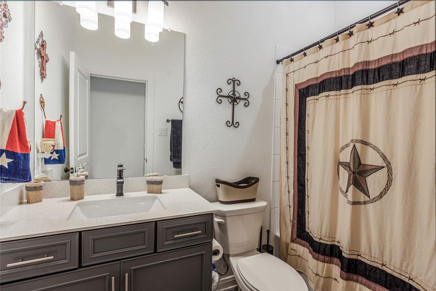 Guest bathroom with a stylish vanity and modern features.