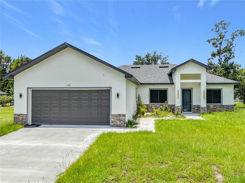 Front exterior of a new home in , Port Charlotte, FL, highlighting curb appeal (Image 27). Front exterior of a new home in , Port Charlotte, FL, highlighting curb appeal (Image 27).