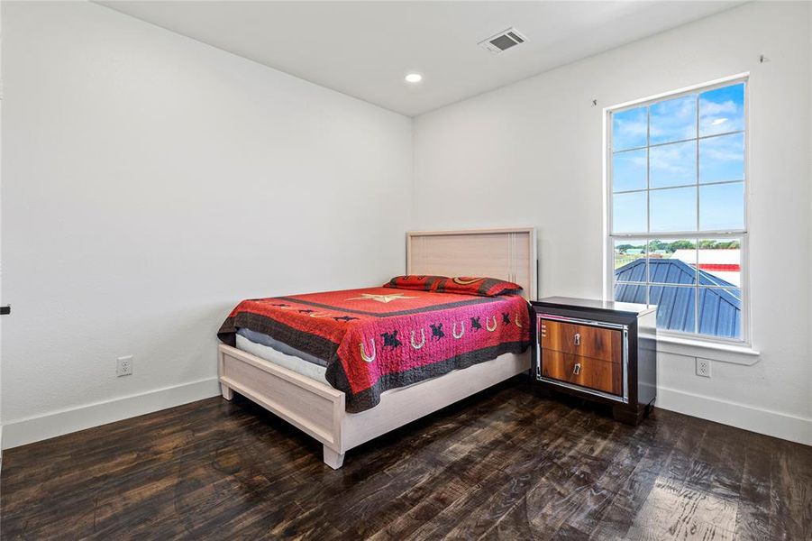 Bedroom featuring dark wood-style flooring and recessed lighting Bedroom featuring dark wood-style flooring and recessed lighting