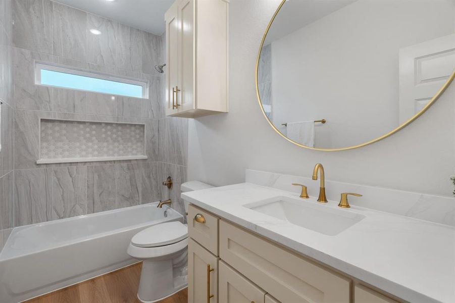 Full bathroom featuring  shower combination, wood finished floors, and vanity