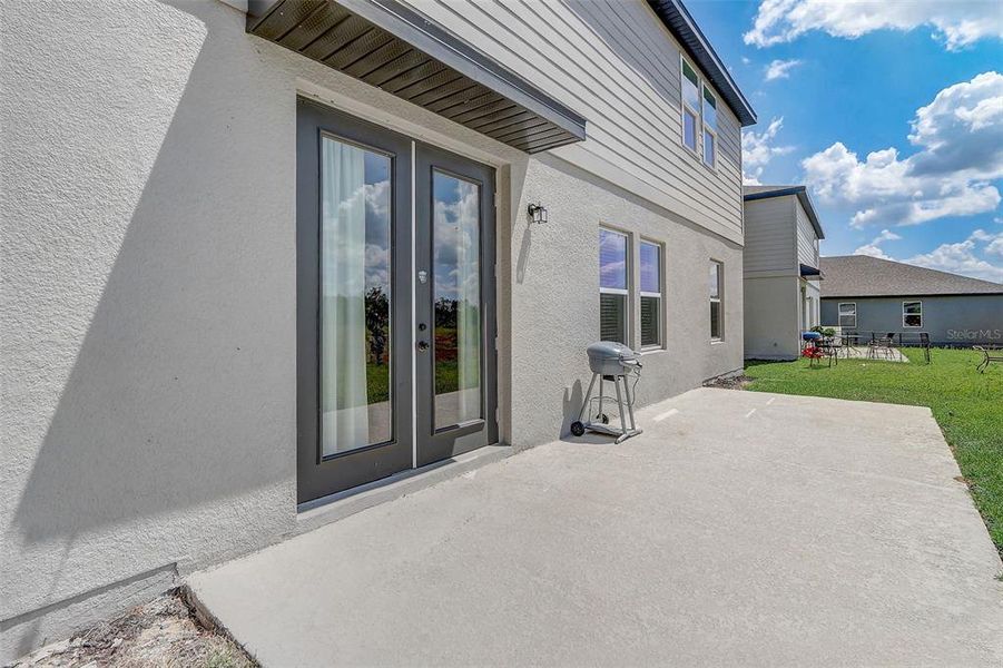 Exterior details and patio area of a home in Glen at West Haven, Davenport (Image 27).