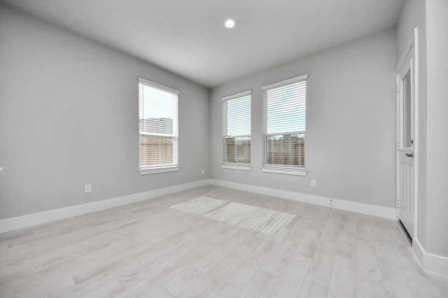 Enjoy breakfast with ease in the connected and cozy breakfast area, seamlessly integrated with the kitchen for utmost convenience. Step through the back door for a breath of fresh air onto the covered patio, extending your living space to the outdoors.