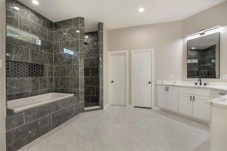Bathroom with vanity, a marble finish shower, a garden tub, recessed lighting, and light marble finish floors Bathroom with vanity, a marble finish shower, a garden tub, recessed lighting, and light marble finish floors