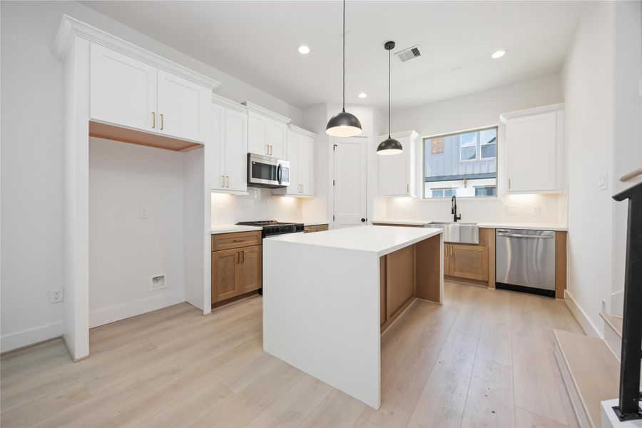 Island Kitchen. This is the base cabinet color throughout the home.