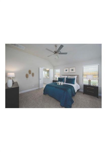 Bedroom with vaulted ceiling, ceiling fan, and carpet